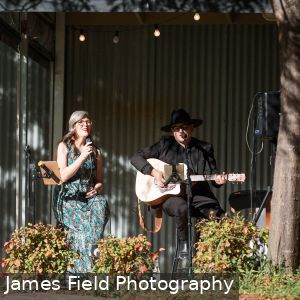Marly Cruse and Katie Fielder from Cruse Entertainment performing acoustic music under a tree at Howard Vineyard in Adelaide South Australia