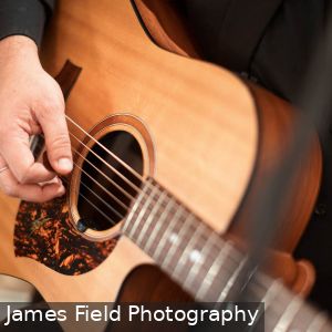 Close up of Marly Cruse from Cruse Entertainment playing acoustic guitar at a wedding at Howard Vineyard in Adelaide South Australia